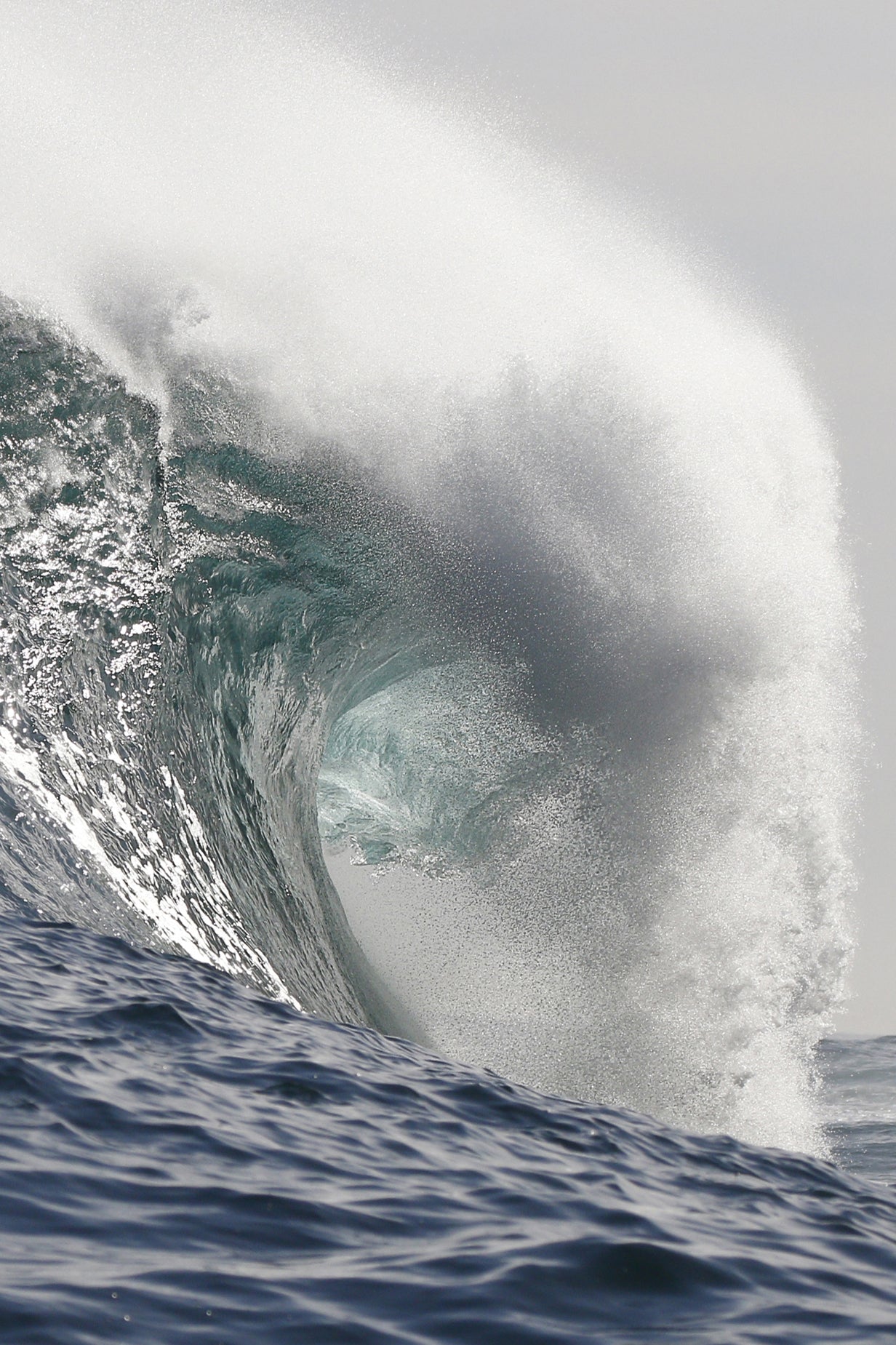Powerful wave curling over itself in the ocean
