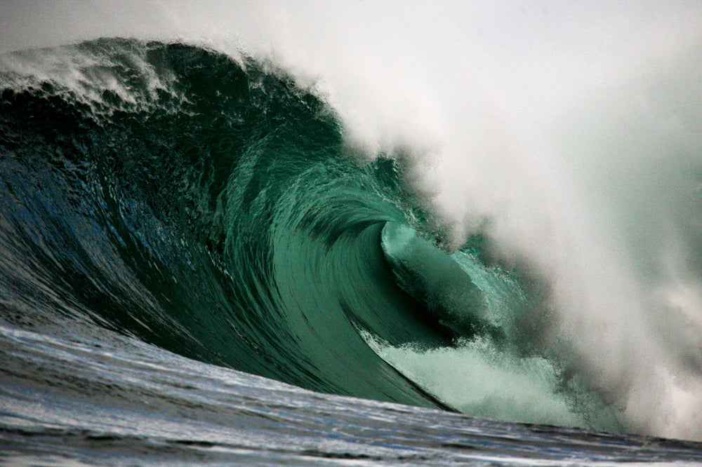 Powerful wave curling over itself in the ocean