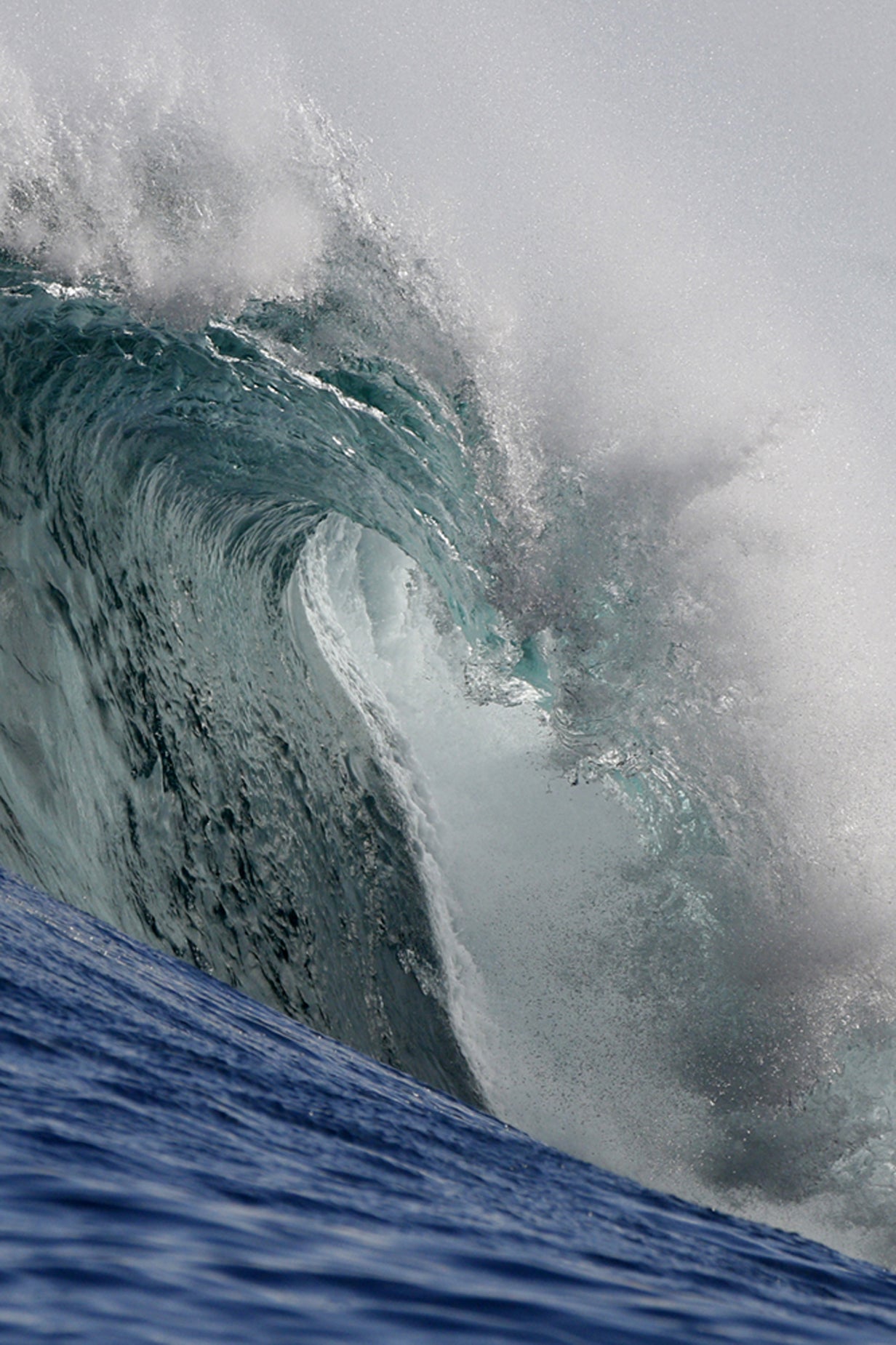 Towering wave crashing down with a hazy background